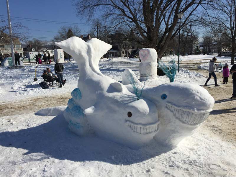 snow sculpture of whales